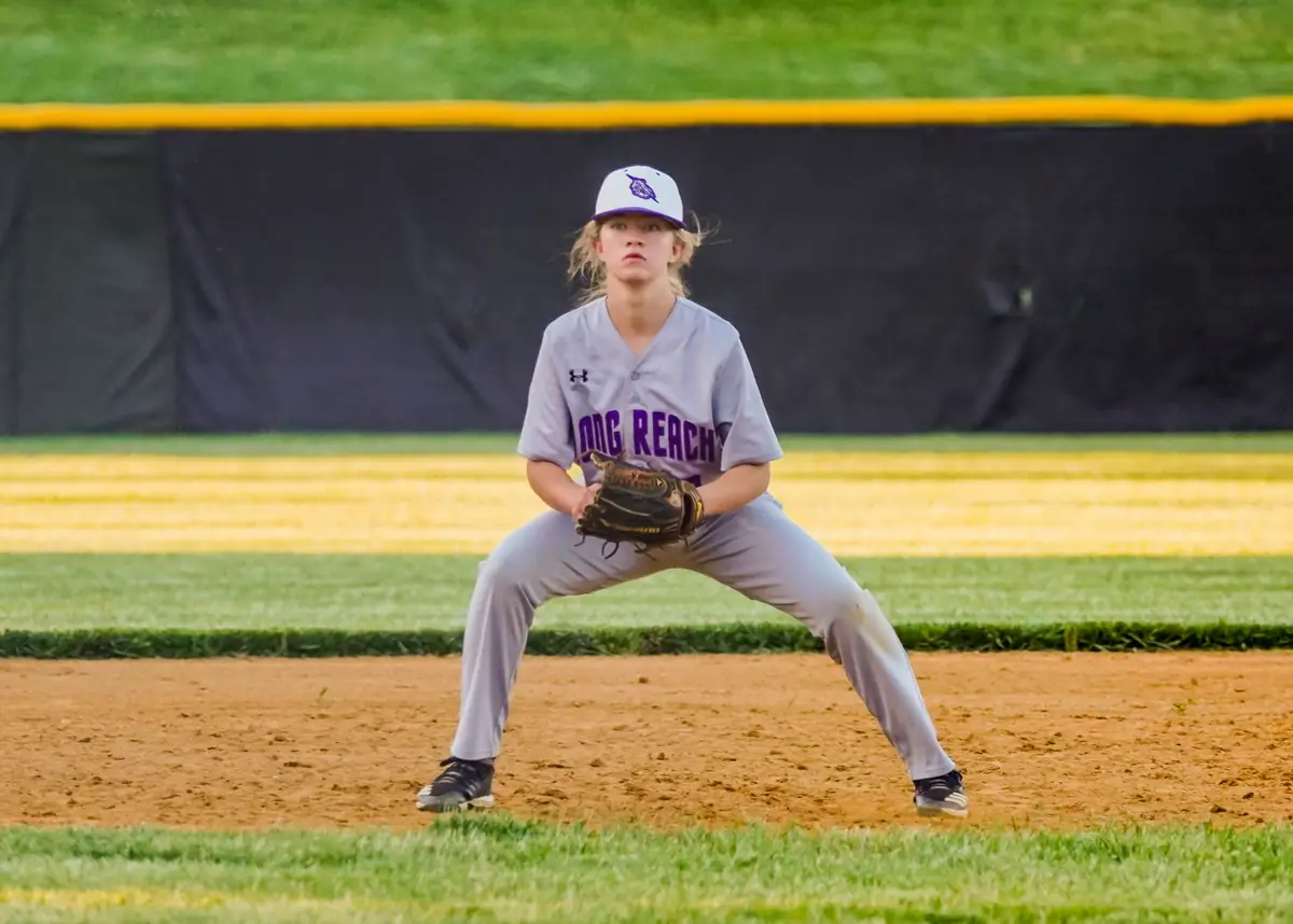 Softball infielder in a ready stance on the field