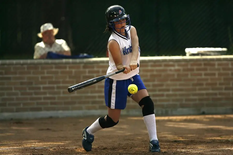 Young softball player bunting at the plate