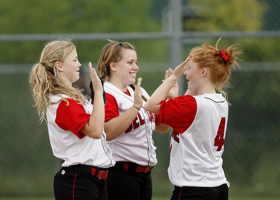 Softball teammates giving each other high fives